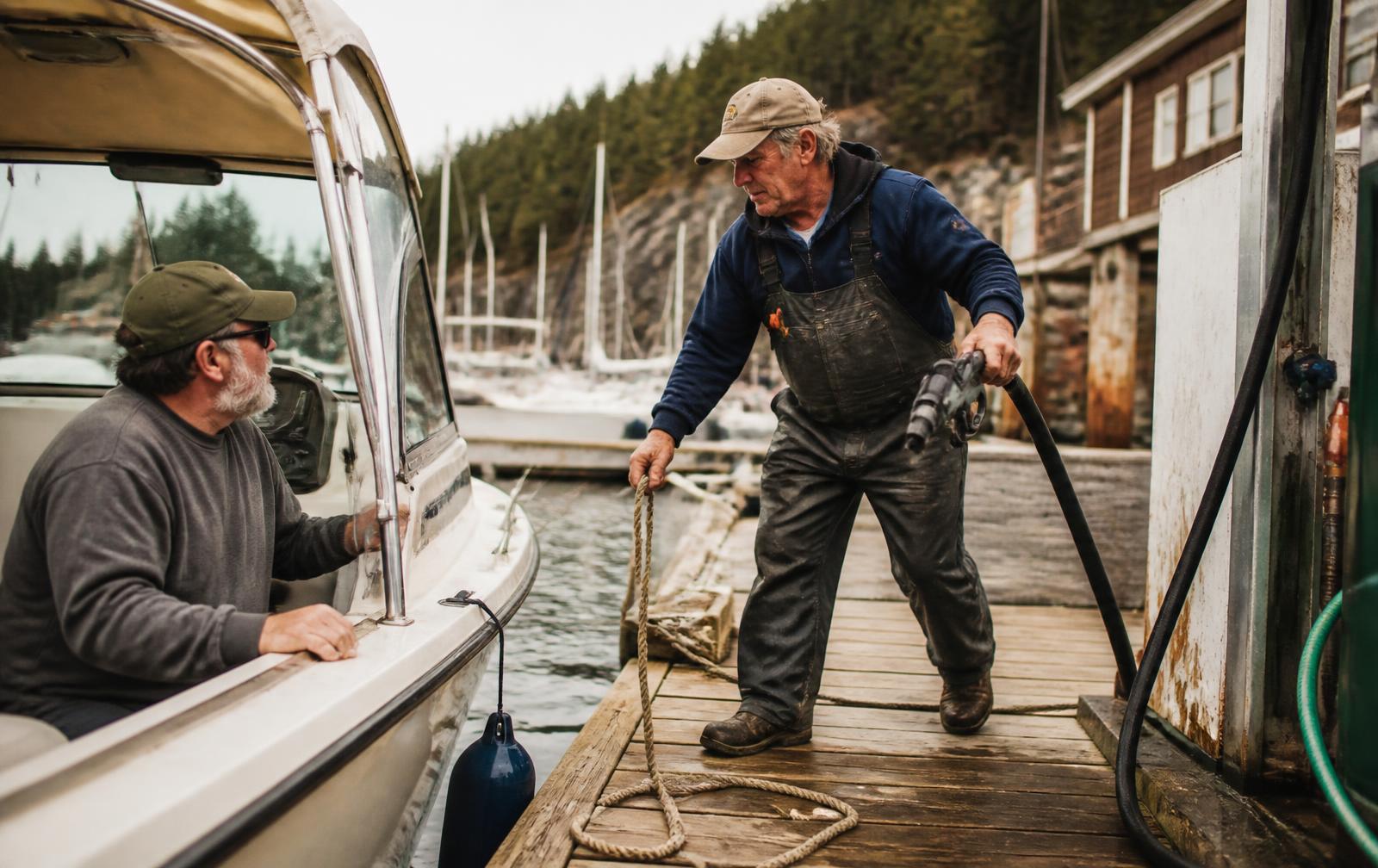 Marina staff member taking a line from a boater at the fuel dock
