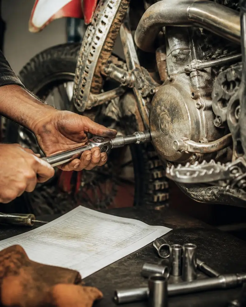 Close-up of a technician's hands and a torque wrench working on a machine at the parts and service counter